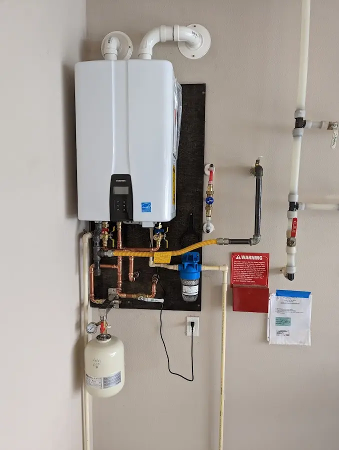 Professional plumber installing copper piping in a South Boston home